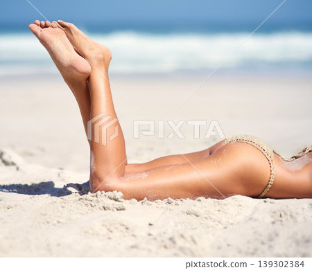 Woman, legs and bikini on beach sand for relax vacation, sea resort for paradise travel. Female person, feet and swimsuit for outdoor costal trip for summer journey or tanning, clean air at ocean Woman, legs and bikini on beach sand for relax vacation, sea resort for paradise travel. Female person, feet and swimsuit for outdoor costal trip for summer journey or tanning, clean air at ocean 139302384