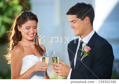 Happy couple, wedding and champagne glasses in celebration for marriage, love or commitment at outdoor ceremony. Married man and woman smile with alcohol for toast, date or cheers on honeymoon Happy couple, wedding and champagne glasses in celebration for marriage, love or commitment at outdoor ceremony. Married man and woman smile with alcohol for toast, date or cheers on honeymoon 139302386