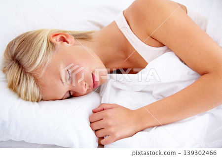 Bedroom, woman and sleeping with peace, fatigue or home with comfort, tired or resting while dreaming. Apartment, girl or exhausted person, taking a nap with a comfortable pillow, relax or blanket 139302466