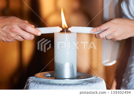 Couple, hands and candle at wedding for unity, love and commitment at church or ceremony with closeup. Marriage, man and woman with light for trust, relationship and faith with bride and groom Couple, hands and candle at wedding for unity, love and commitment at church or ceremony with closeup. Marriage, man and woman with light for trust, relationship and faith with bride and groom 139302494