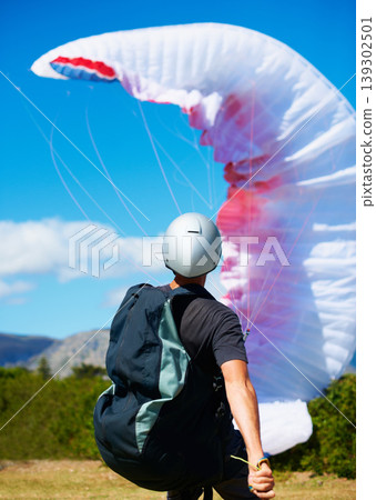 Man, parachute and launch sport with courage, healthy adventure and paragliding for extreme fitness. Person, preparation and fearless in forest for flight take off with helmet and safety gear in wind 139302501