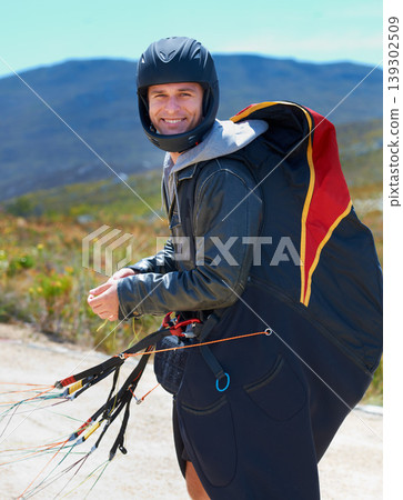 Paragliding, parachute or man in nature in portrait, smile or strings for exercise for health support. Athlete, face and training with happy for outdoor fitness, helmet and equipment in countryside Paragliding, parachute or man in nature in portrait, smile or strings for exercise for health support. Athlete, face and training with happy for outdoor fitness, helmet and equipment in countryside 139302509