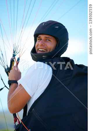 Man, parachute or launch in nature for sport, happy or exercise for healthy adventure for extreme fitness. Person, strings or smile for outdoor fun in wellness, helmet or safety gear in countryside 139302559