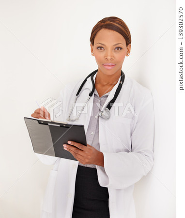 Doctor portrait, woman and charts or documents for medical information, test results or evaluation in clinic. Face of african healthcare worker writing in folder on a wall or white background Doctor portrait, woman and charts or documents for medical information, test results or evaluation in clinic. Face of african healthcare worker writing in folder on a wall or white background 139302570