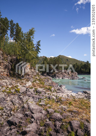 A tranquil mountain river winds past rocky shores, Siberia A tranquil mountain river winds past rocky shores, Siberia 139302605