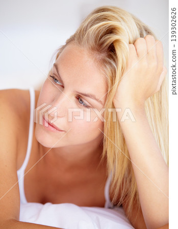 Woman, thinking and lying on bed in closeup for relaxing, peaceful or calmness for quiet. Female person, idea or vision for resting, activity and alone with facial expression for wellness in home Woman, thinking and lying on bed in closeup for relaxing, peaceful or calmness for quiet. Female person, idea or vision for resting, activity and alone with facial expression for wellness in home 139302626