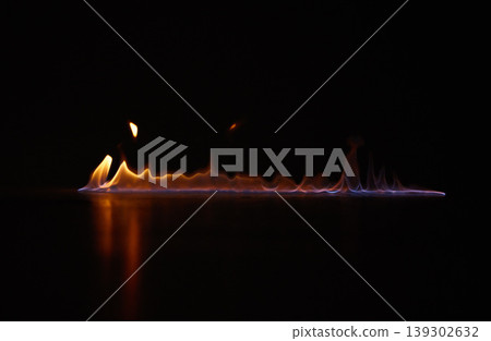 Flame, heat and gas fire with black background with sparks, smoke and light from burning in studio. Fuel, flare and glow from thermal power and art in the dark with creativity and inferno with burn Flame, heat and gas fire with black background with sparks, smoke and light from burning in studio. Fuel, flare and glow from thermal power and art in the dark with creativity and inferno with burn 139302632