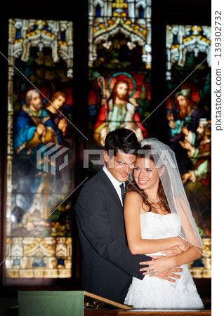 Happy couple, hug and wedding at church for marriage, love or vow in commitment together. Married man or groom hugging woman or bride with smile for embrace, loyalty or support in trust at ceremony 139302732