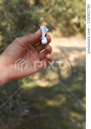 Hand, packet and drugs outdoor in forest for cocaine, recreation or unhealthy habit with package. Person, powder or holding paper with pharmaceutical, illegal and trees for party, event or social Hand, packet and drugs outdoor in forest for cocaine, recreation or unhealthy habit with package. Person, powder or holding paper with pharmaceutical, illegal and trees for party, event or social 139302780