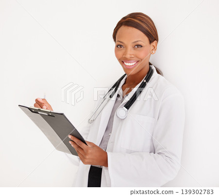 Doctor portrait, woman with charts and writing of medical documents, report or information of patient history in studio. Face of healthcare worker and clinic folder or checklist on a white background Doctor portrait, woman with charts and writing of medical documents, report or information of patient history in studio. Face of healthcare worker and clinic folder or checklist on a white background 139302783
