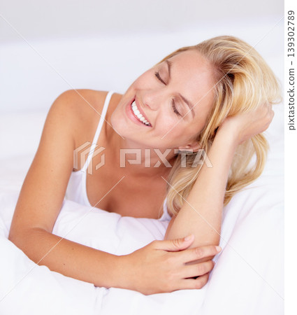 Happy woman, smile and eyes closed for relaxing in bedroom for quiet, peaceful and calmness. Female person, cheerful or joyful expression on face for resting, zen or comfort alone in home with pillow Happy woman, smile and eyes closed for relaxing in bedroom for quiet, peaceful and calmness. Female person, cheerful or joyful expression on face for resting, zen or comfort alone in home with pillow 139302789
