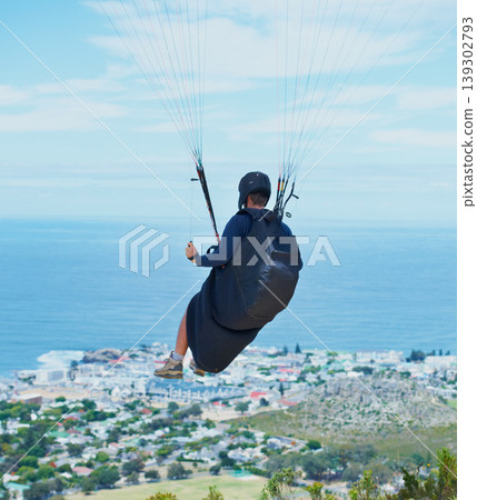 Man, parachute or paragliding in blue sky for ocean view, flight freedom or adventure in extreme sport. Pilot, nature and fearless in outdoor fitness for health, sports and wellness with glide in air 139302793
