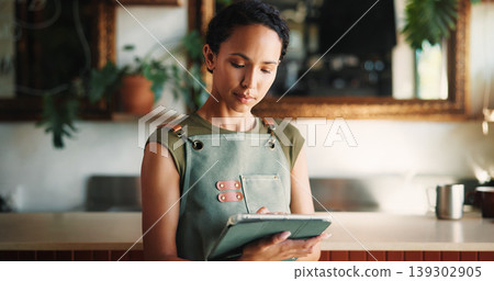 Hospitality, tablet and woman in cafe, internet and service for online order, email and startup website. Barista, entrepreneur or person in restaurant, tech for inventory or planning menu with apron Hospitality, tablet and woman in cafe, internet and service for online order, email and startup website. Barista, entrepreneur or person in restaurant, tech for inventory or planning menu with apron 139302905