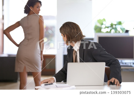 Ethics, sexual harassment and a business man in the office with a woman colleague. Fantasy, company or affair with a male employee looking at the back of a female coworker in the corporate workplace Ethics, sexual harassment and a business man in the office with a woman colleague. Fantasy, company or affair with a male employee looking at the back of a female coworker in the corporate workplace 139303075