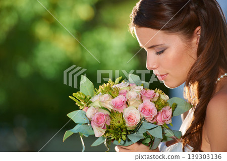 Woman, smell and wedding rose bouquet with love, commitment and trust ceremony for marriage. Engagement, celebration and flowers for event in a park with a red floral plant and bride dress outdoor Woman, smell and wedding rose bouquet with love, commitment and trust ceremony for marriage. Engagement, celebration and flowers for event in a park with a red floral plant and bride dress outdoor 139303136