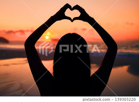 Woman, silhouette and sunset at beach with heart hands for love, care and kindness with sign, summer and dusk. Girl, person and ocean with symbol, emoji or icon on vacation, nature or outdoor in dark Woman, silhouette and sunset at beach with heart hands for love, care and kindness with sign, summer and dusk. Girl, person and ocean with symbol, emoji or icon on vacation, nature or outdoor in dark 139303220