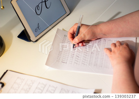 Close up of woman hand training handwriting. Activation of unique cognitive and motor circuits, enhancing memory retention, focus and deep concentration concept 139303237