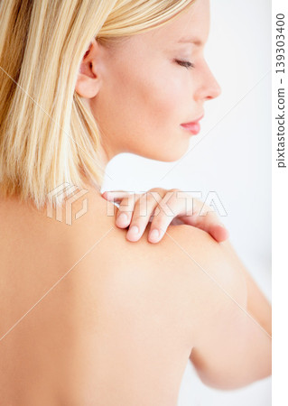 Girl, skincare and touch shoulder in studio with back, eyes closed and beauty by white background. Woman, model and thinking with peace, cosmetic change and transformation with glow for wellness Girl, skincare and touch shoulder in studio with back, eyes closed and beauty by white background. Woman, model and thinking with peace, cosmetic change and transformation with glow for wellness 139303400