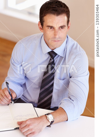 Businessman at desk thinking, writing and notes for market research, business plan and insight at startup. Office, notebook and man with schedule, agenda or to do list in book with ideas for project. 139303464