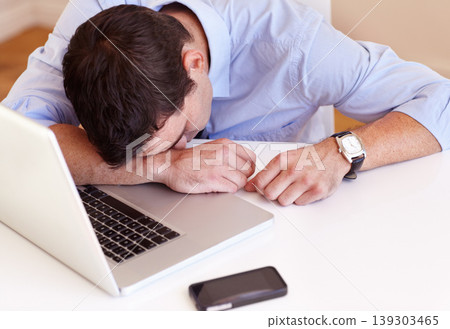 Business man, sleep and laptop at desk in office with fatigue, frustrated or tired for stress in workplace. Accountant, computer and burnout with smartphone, exhausted or overtime at financial agency Business man, sleep and laptop at desk in office with fatigue, frustrated or tired for stress in workplace. Accountant, computer and burnout with smartphone, exhausted or overtime at financial agency 139303465