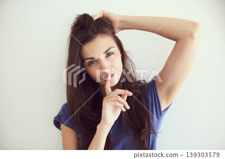 Portrait, woman and finger on the lips with a secret, emoji and gossip on white studio background. Face, person and model with privacy, whisper or confidential information with body language or shush Portrait, woman and finger on the lips with a secret, emoji and gossip on white studio background. Face, person and model with privacy, whisper or confidential information with body language or shush 139303579