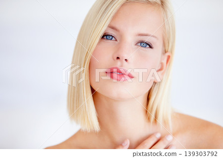 Woman, beauty and touch in studio portrait for wellness, skincare and health by white background. Girl, model and facial change for skin, cosmetic care and transformation with pride for natural glow Woman, beauty and touch in studio portrait for wellness, skincare and health by white background. Girl, model and facial change for skin, cosmetic care and transformation with pride for natural glow 139303792