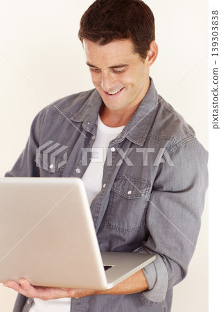 Man, laptop and smile in studio for remote work, elearning and search subscription for digital download on white background. Happy freelancer typing on computer to update blog, online shopping or web Man, laptop and smile in studio for remote work, elearning and search subscription for digital download on white background. Happy freelancer typing on computer to update blog, online shopping or web 139303838