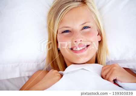 Women, smile and bed in morning, portrait and ready for day with happiness, positive and joyful. Comfortable, bedroom and relaxing for healthy rest, pillow and blanket from above, alone and wake up Women, smile and bed in morning, portrait and ready for day with happiness, positive and joyful. Comfortable, bedroom and relaxing for healthy rest, pillow and blanket from above, alone and wake up 139303839
