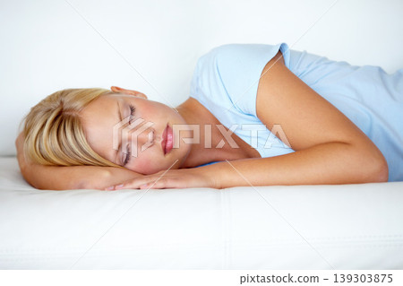 Home, relax and woman on a couch, sleeping and resting with weekend break, peaceful and calm. Person on a sofa, apartment and girl with fatigue, feeling tired and afternoon nap in a living room 139303875