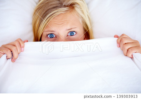 Portrait, bedroom and blanket with woman, fear and scared with anxiety, expression and emotion. Face, person and girl with a sheet, home and depression with stress, mental health and insomnia Portrait, bedroom and blanket with woman, fear and scared with anxiety, expression and emotion. Face, person and girl with a sheet, home and depression with stress, mental health and insomnia 139303913