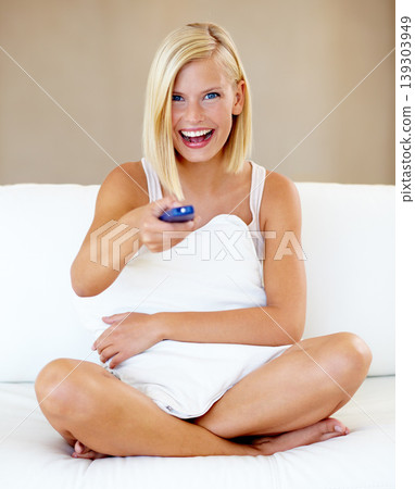 Relax, portrait and happy woman on sofa watching tv with remote, pillow and streaming movies in home. Smile, television and girl on couch in living room with choice of fun video, film or network show Relax, portrait and happy woman on sofa watching tv with remote, pillow and streaming movies in home. Smile, television and girl on couch in living room with choice of fun video, film or network show 139303949