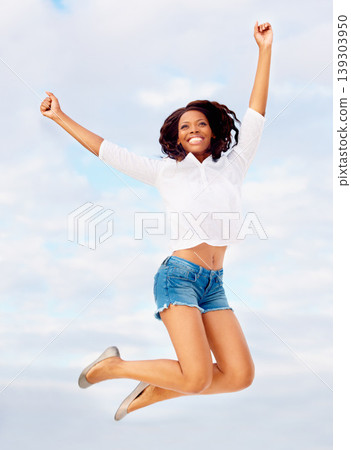 Black woman, jumping and excited in air with travel, vacation of winner happy from holiday. Winning, African person and leap with joy from celebration, achievement and freedom outdoor with smile Black woman, jumping and excited in air with travel, vacation of winner happy from holiday. Winning, African person and leap with joy from celebration, achievement and freedom outdoor with smile 139303950