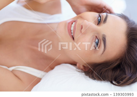 Portrait, beauty and a woman on her bed in the home to relax alone on the morning of a weekend from above. Face, smile and wellness with a happy young person in the bedroom of her apartment to rest Portrait, beauty and a woman on her bed in the home to relax alone on the morning of a weekend from above. Face, smile and wellness with a happy young person in the bedroom of her apartment to rest 139303993