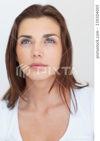 Woman, beauty and thinking of natural skincare on a white studio background. Vision, face and attractive model with dermatology closeup for future thought on a backdrop with makeup and cosmetics 139304005