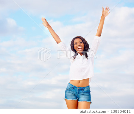 Black woman, yes and excited with arms in the air with travel, vacation of winner happy from holiday. Winning, African person and celebration with joy from energy, achievement and freedom with smile 139304011