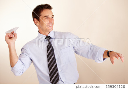 Business man, throw paper plane and happy for thinking, vision or game with transport symbol by white background. Entrepreneur, airplane and smile with ideas, icon and playful at accounting agency 139304128