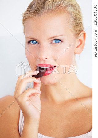 Candy woman, portrait and eating chocolate bar, delicious snack or studio wellness treat, junk food or dessert. Headshot, sugar addiction temptation and female person cacao sweets on white background 139304130