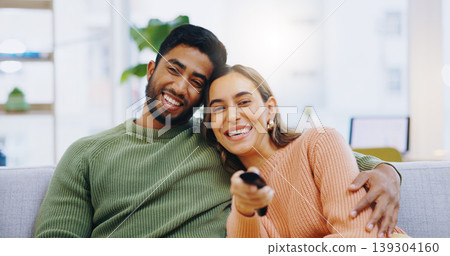 Couple, watching tv and remote on living room couch with smile, hug or relax with click for choice, show or film. Man, woman and happy together for embrace, movie or streaming on lounge sofa in home Couple, watching tv and remote on living room couch with smile, hug or relax with click for choice, show or film. Man, woman and happy together for embrace, movie or streaming on lounge sofa in home 139304160