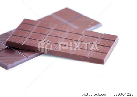 Chocolate bar, studio candy and sugar sweets for delicious temptation, wellness or tasty dessert treat, cacao slab or snack. Unhealthy junk food, product quality and premium cocoa on white background Chocolate bar, studio candy and sugar sweets for delicious temptation, wellness or tasty dessert treat, cacao slab or snack. Unhealthy junk food, product quality and premium cocoa on white background 139304223