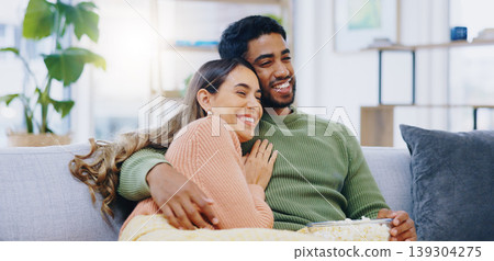 Love, hug and couple on watching tv on a sofa with popcorn for movie, film or streaming show at home. Relax, television and people embrace in a living room with cinema snack for comedy or series Love, hug and couple on watching tv on a sofa with popcorn for movie, film or streaming show at home. Relax, television and people embrace in a living room with cinema snack for comedy or series 139304275