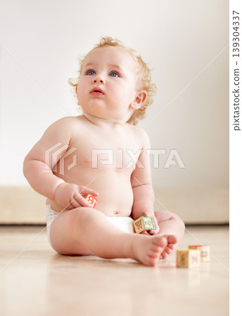 Baby, boy and building blocks on a floor for learning, playing or having fun in a nursery room. Little, cute and curious kid relax with toy for child development, coordination or educational skills Baby, boy and building blocks on a floor for learning, playing or having fun in a nursery room. Little, cute and curious kid relax with toy for child development, coordination or educational skills 139304337