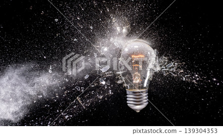 Real Light bulb exploding creating shattered glass impact Real Light bulb exploding creating shattered glass impact 139304353