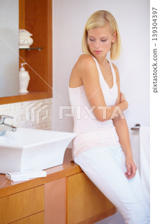 Worry, anxiety and woman with pregnancy test in bathroom waiting for results, news and information. Motherhood, pregnant and sad person with medical testing kit for fertility or ovulation at home 139304397