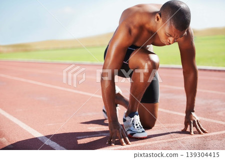 Man, athlete and ready for run on track with practice, training or workout for race. Black person, determination and concentration on face for go, speed and fast for athletics, sport and performance Man, athlete and ready for run on track with practice, training or workout for race. Black person, determination and concentration on face for go, speed and fast for athletics, sport and performance 139304415