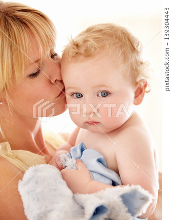 Love, kiss and face of baby with mother in a house for bonding, playing or care, trust or growth. Family, support and mom embrace boy kid in their home for child development, security or having fun Love, kiss and face of baby with mother in a house for bonding, playing or care, trust or growth. Family, support and mom embrace boy kid in their home for child development, security or having fun 139304443