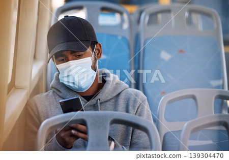 Man in bus with mask, phone and morning travel in city, checking service schedule or social media post. Public transport safety in covid, urban commute and person in seat with smartphone connection. 139304470