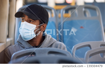 Man, mask or thinking in bus in city, cold protection or window view on trip for wellness. Young person, cap or medical cover on mouth for flu virus, transport safety or healthcare rules on vehicle Man, mask or thinking in bus in city, cold protection or window view on trip for wellness. Young person, cap or medical cover on mouth for flu virus, transport safety or healthcare rules on vehicle 139304479