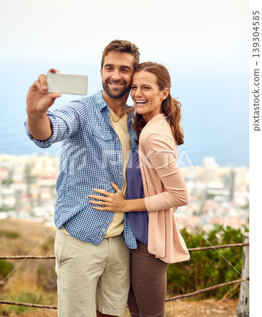 Couple, hug and selfie on phone, love and outdoors on vacation, laughing and memories for social media. Happy people, smartphone and adventure or technology, travel and humor on holiday, fun and joke Couple, hug and selfie on phone, love and outdoors on vacation, laughing and memories for social media. Happy people, smartphone and adventure or technology, travel and humor on holiday, fun and joke 139304585