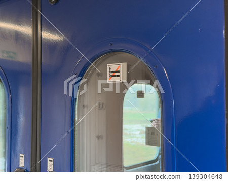 Train carriage door with no smoking symbol on window, signifying travel regulations and public transportation rules Train carriage door with no smoking symbol on window, signifying travel regulations and public transportation rules 139304648