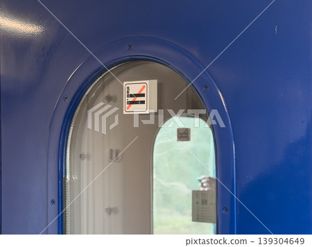 No Smoking Sign Attached to Blue Train Door Window, Enforcing Smoke-Free Environment for Passengers' Health and Comfort No Smoking Sign Attached to Blue Train Door Window, Enforcing Smoke-Free Environment for Passengers' Health and Comfort 139304649